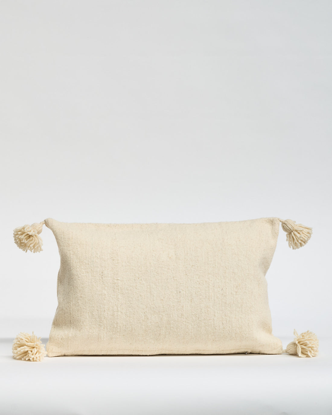 Wool Cushion with Pom Poms 60x40cms Cream